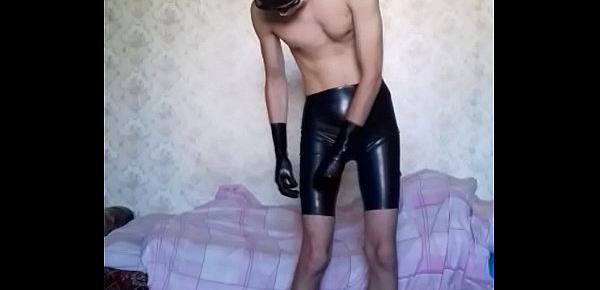  Guy putting on long latex shorts